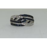 A 14ct white gold Sapphire and Diamond banded ring. Size N