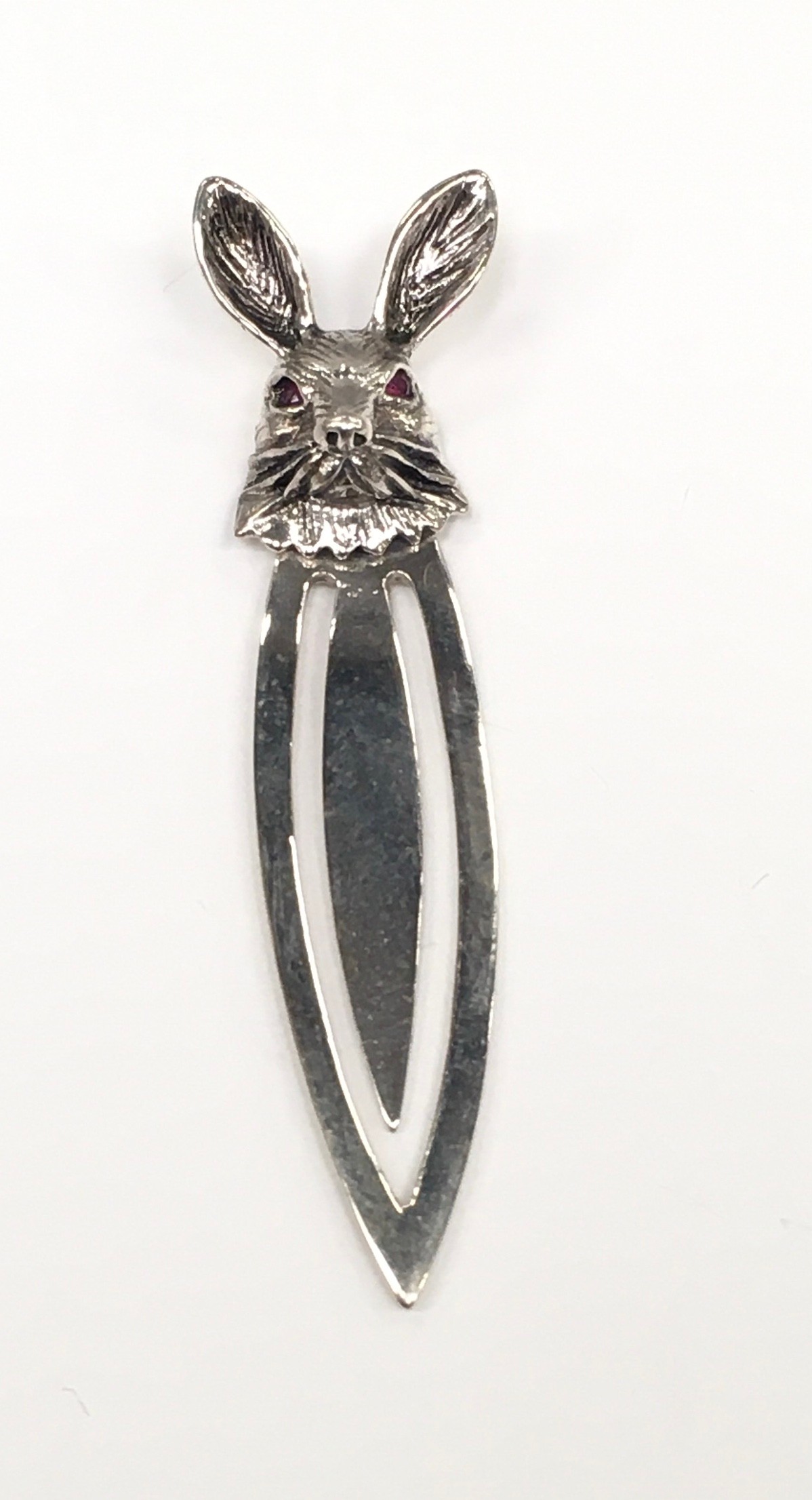A silver bookmark with rabbit finial.