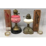 Two vintage Aladdin oil lamps with boxed Aladdin glass chimney's.
