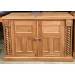 Solid Pine two door cupboard with twist supports and carved motifs, fitted internal shelf