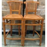 A pair of modern oak high back bar stools each measuring 106x45x40cm. Seat height 73cm.