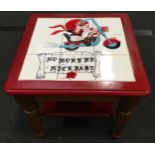 Red painted coffee table with custom painted tiled top of baby on a motorcycle "No More Mr Nice