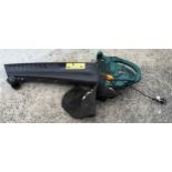 A portable leaf blower/vacuum with attached bag.