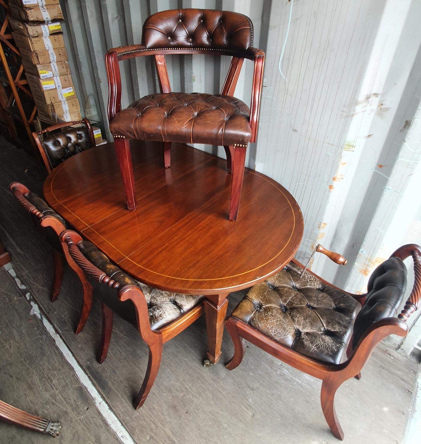 Victorian mahogany wind out extendable dining table on tapered lags together with five matching