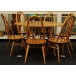 Ercol blonde drop leaf dining table together with a set of six Ercol blonde model 365 Quaker