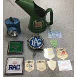 Original Castrol oil jug along with various badges and vintage bike light.