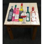 A custom made tiled top pine occasional table depicting alcohol 41x40x40cm.