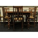 Antique oak draw leaf dining table with cross stretcher and barley twist supports together with a