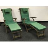 A pair of vintage oak steamer chairs with cushions.