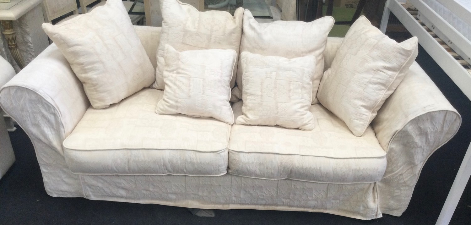 A large three seater settee with hexagonal back upholstered in beige fabric 230x120x70cm.