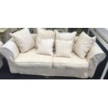 A large three seater settee with hexagonal back upholstered in beige fabric 230x120x70cm.