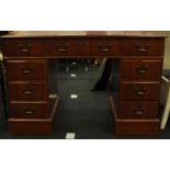 A mahogany pedestal desk of small proportions with brass handles to front fitted with 9 drawers
