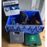 A blue crate containing caravan battery charger, hot air blow torch, security light, sander and