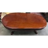 Mahogany oval shaped coffee table on decorative base 140x46x80cm.