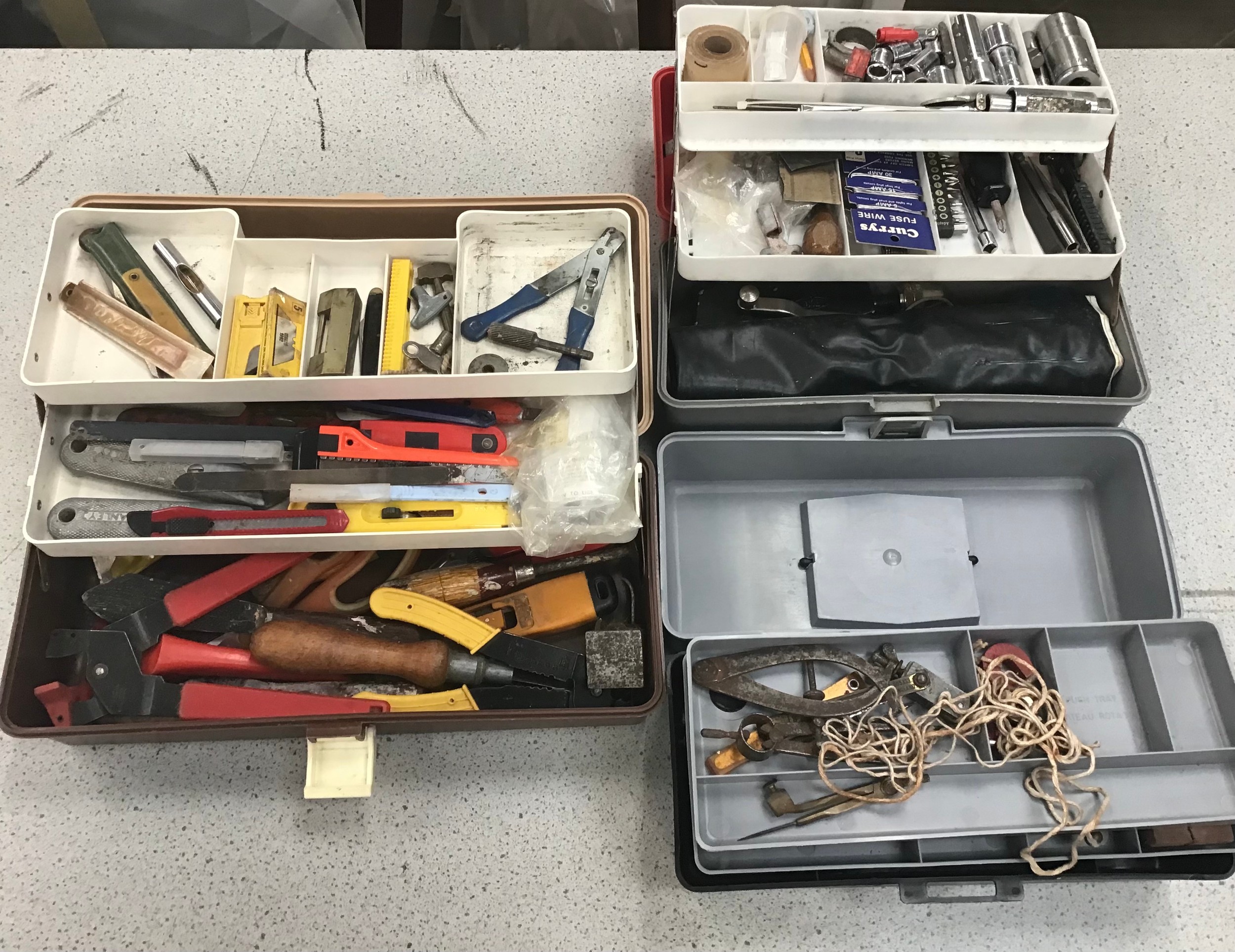 3 plastic tool boxes with various tools.