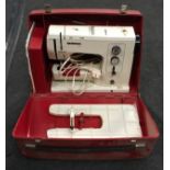 Bernina Record electric sewing machine with power lead, instructions and accessories in red case.
