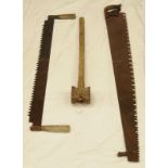 Pair of large vintage two man crosscut saws along with a vintage long handled post mallet