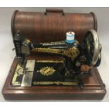 A vintage Singer sewing machine in wooden case.