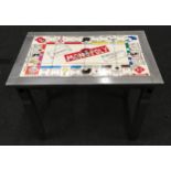 A custom made silver painted table with tiled top depicting Monopoly 66x42x54cm.