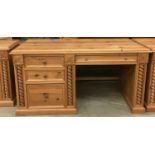 Solid pine desk with 3 side draws and a central draw turned up supports and carved motif