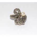 A silver designer style ring of panther form set with marcasite and pearl