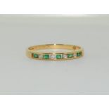 An 18ct Emerald and diamond ring (millennium) Size P