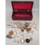 A wooden box of antique and other costume jewellery to include Silver and gold.