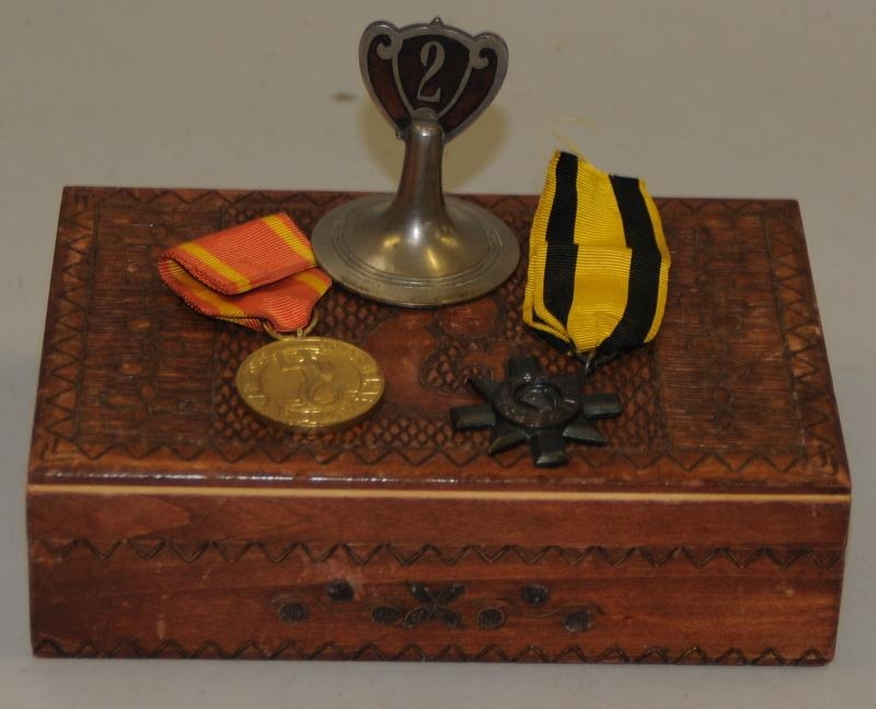 Polish WWII medal and an 1896 Ashanti Star in a carved wooden box