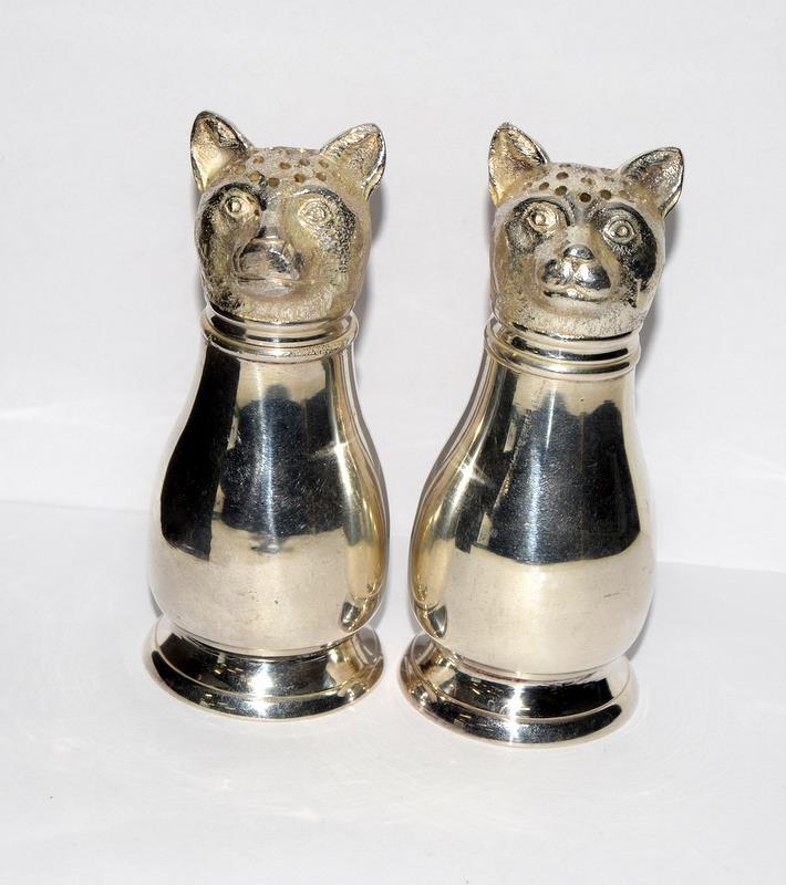 A pair of large silver plated cat condiments.