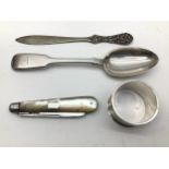 A selection of solid silver items to include Napkin, large fruit knife, desert spoon and letter