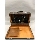 Singer 99K vintage electric sewing machine with original sewing attachments and accessories.
