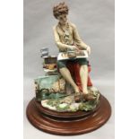 Capodimonte figurine of a boy painting approx 34cm in height.