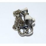 A silver cat shaped brooch set with marcasites.