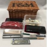 Collection of vintage pens and some stamps. All contained in a small Fortnum and Mason wicker basket