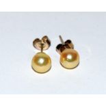 A pair of freshwater pearl stud earrings.