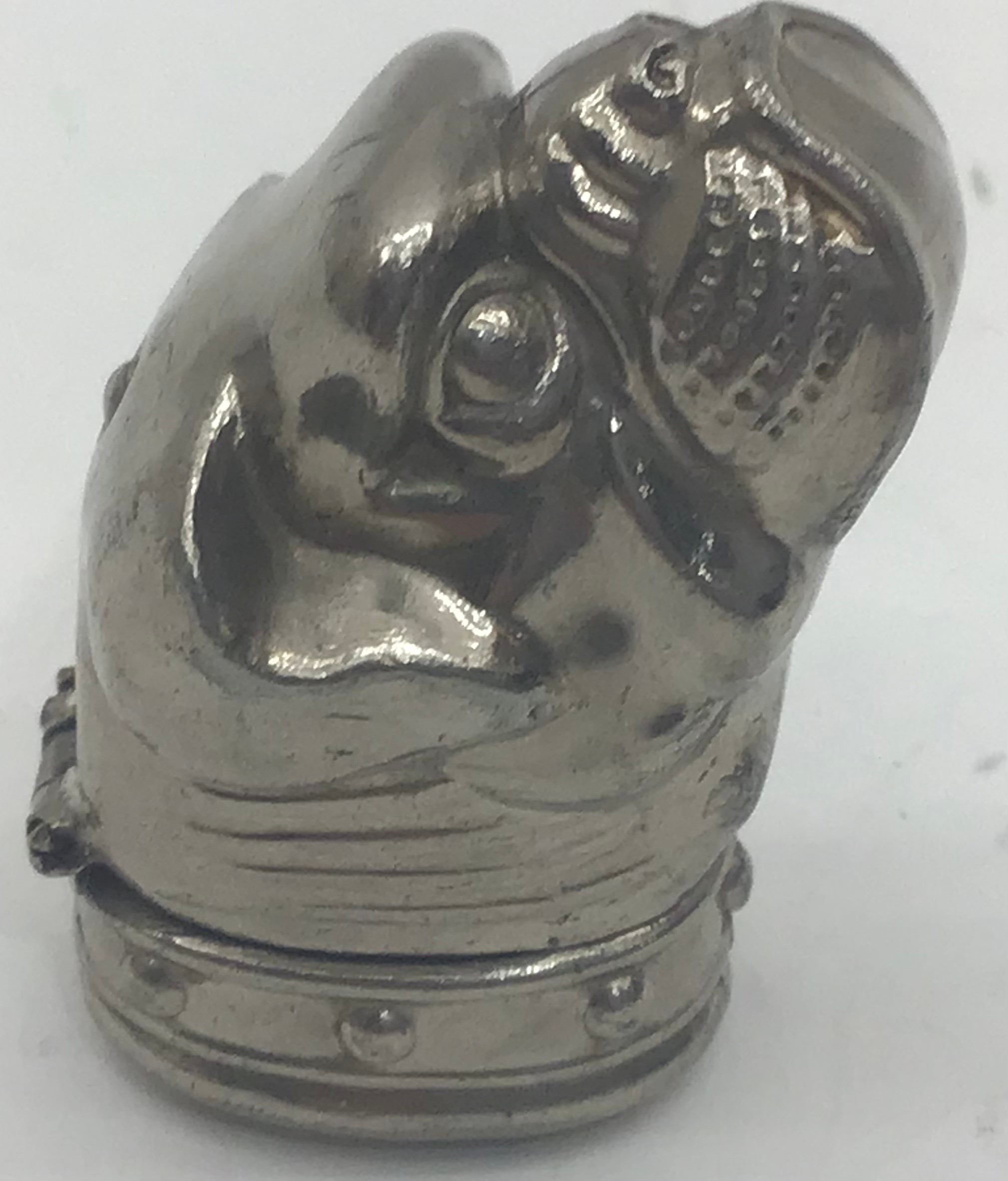 A silver plated novelty vest case of a boxer dog.