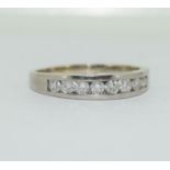 An 18ct white gold seven stone diamond half eternity ring 1ct approx size N