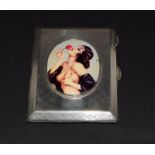 A silver 1923 case with semi nude enamel panel.