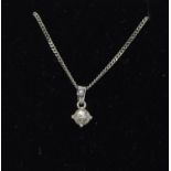 An 18ct white gold single stone diamond pendant of 36 points.