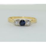 An 18ct sapphire and diamond ring, Size M