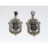 A pair of silver Art Deco style drop earrings in the form of cats.