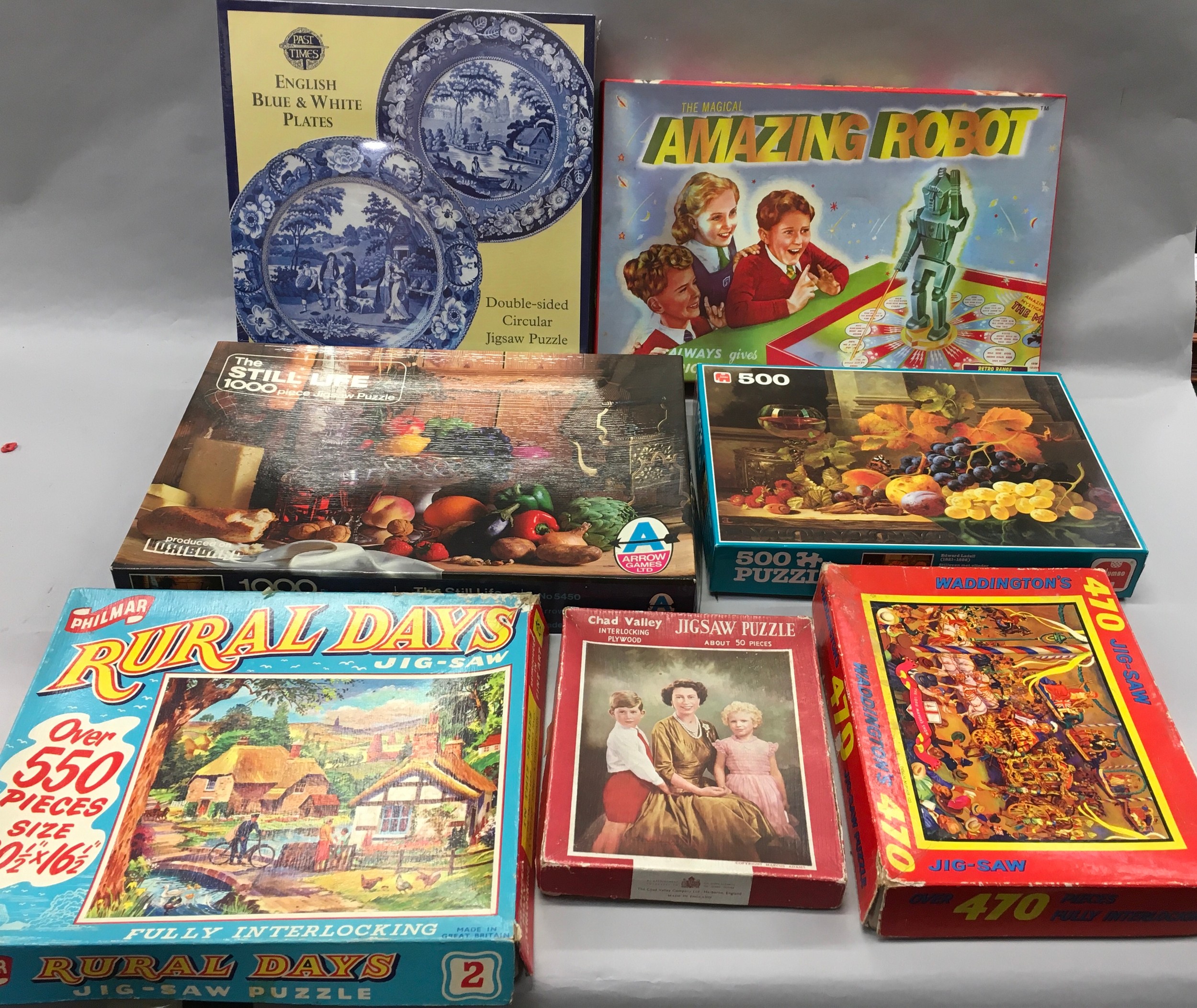 Collection of vintage jigsaw puzzles complete with boxed amazing robot game.