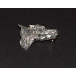 A silver horse head brooch.