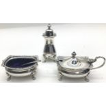 A solid silver cruet set with blue liners and two silver spoons weight without liners 200gms, with