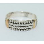 A Designer Suarti 925 silver and 18K ring, Size V