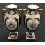 A pair of oriental porcelain twin handled urns each 42cm tall.