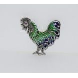 A silver and plique a jour rooster brooch with ruby eye.