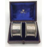 Pair of engraved silver hallmarked napkin rings in fitted box marked "Goldsmith's Alliance