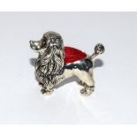 A silver poodle pin cushion.