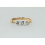 An 18ct gold ring with three diamonds, Size N